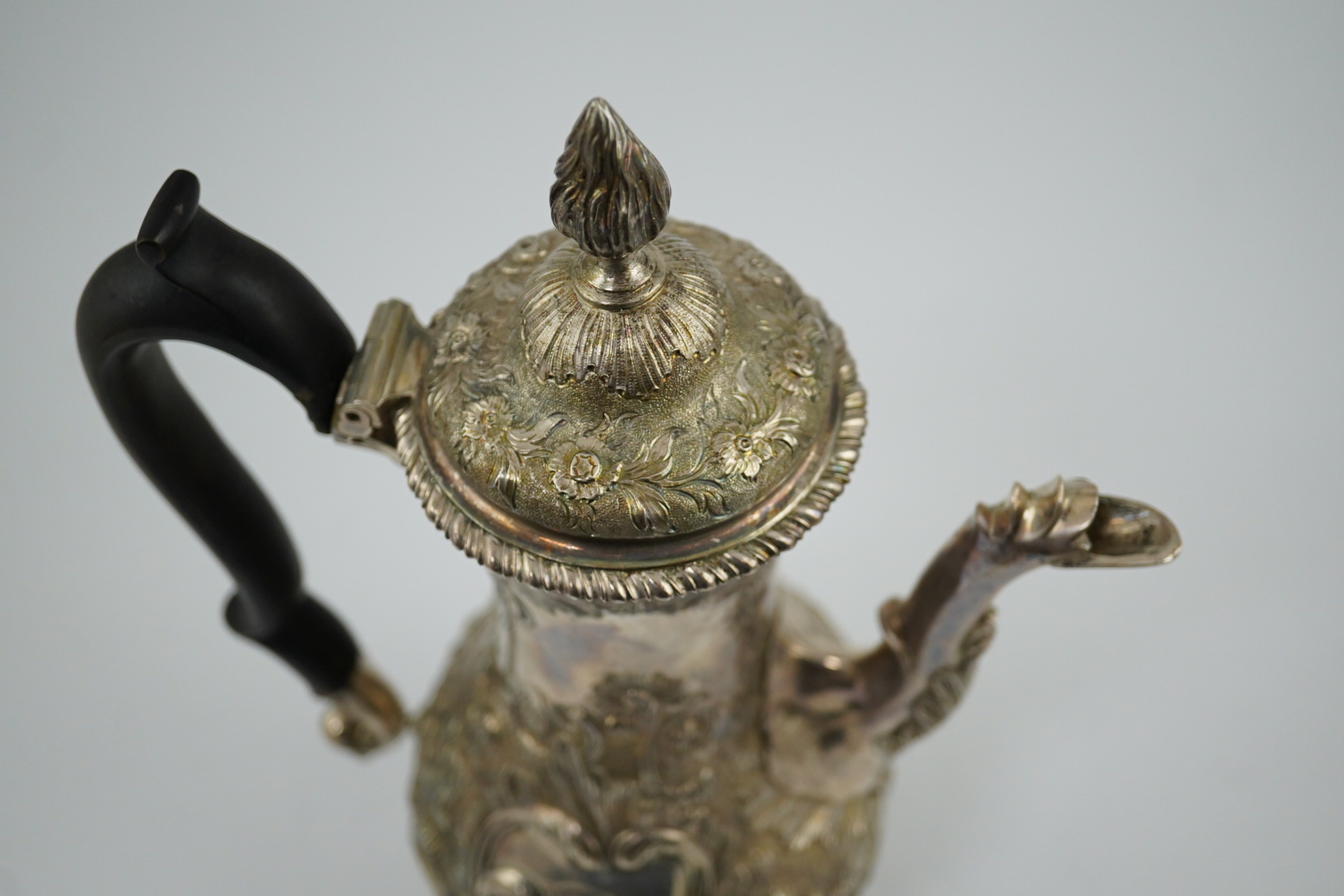 A George III silver coffee pot, by Aldridge & Green, with later embossed decoration